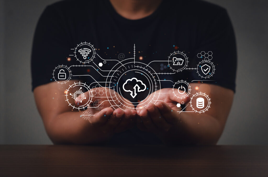 Person holding a digital cloud network with technology icons representing IT infrastructure